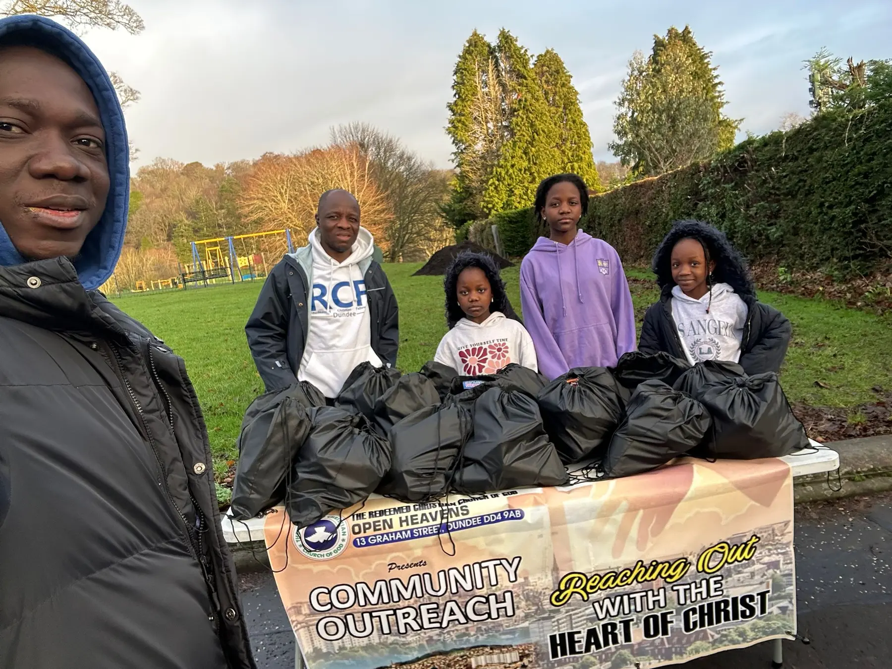Open Heavens Dundee adults and children volunteering with food and essential-support parcels